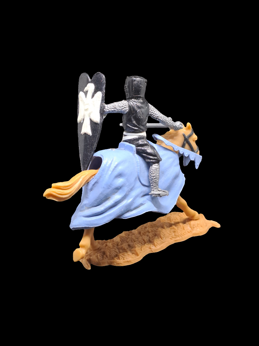 Knight on horse with sword and shield.